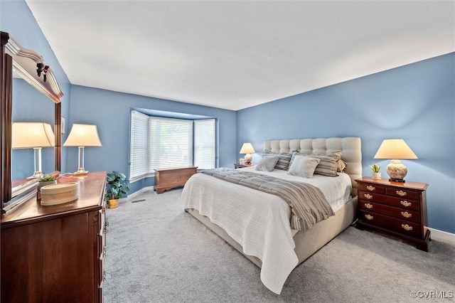 carpeted bedroom featuring baseboards
