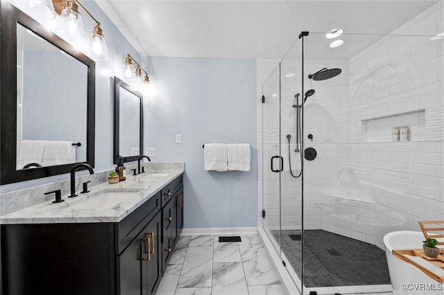 full bathroom with marble finish floors, baseboards, a stall shower, double vanity, and a freestanding tub