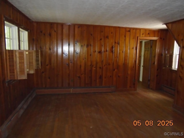3740 Turner Rd, Richmond, VA 23832 - unfurnished room with a baseboard heating unit, wood walls, wood finished floors, and healthy amount of natural light