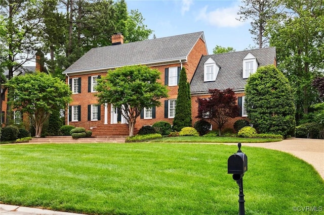 11458 Barrington Bridge Ct, Henrico, VA 23233 - view of front facade with a chimney, a front yard, and brick siding