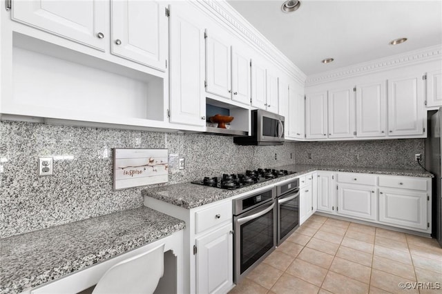 11458 Barrington Bridge Ct, Henrico, VA 23233 - kitchen with stainless steel appliances, white cabinetry, light tile patterned floors, tasteful backsplash, and crown molding