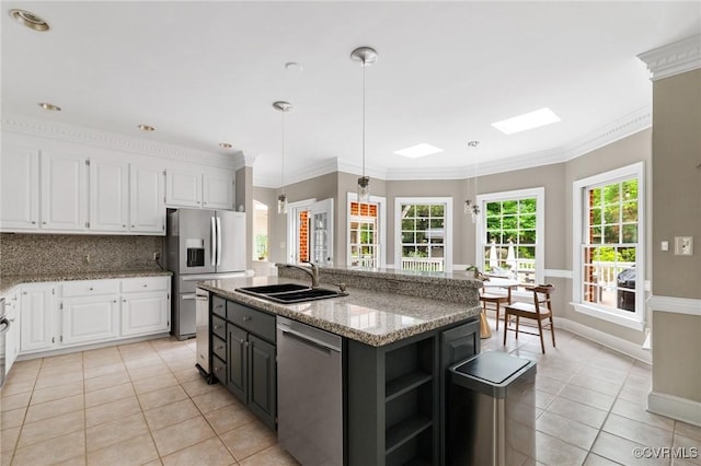 11458 Barrington Bridge Ct, Henrico, VA 23233 - kitchen featuring appliances with stainless steel finishes, a sink, light tile patterned flooring, white cabinets, and crown molding