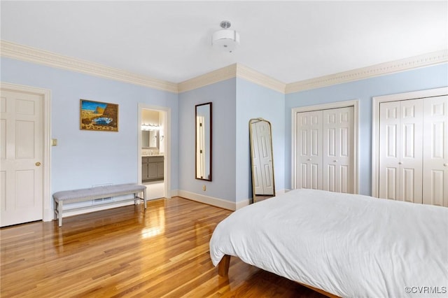 11458 Barrington Bridge Ct, Henrico, VA 23233 - bedroom featuring light wood-style flooring, two closets, crown molding, and baseboards