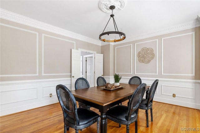 11458 Barrington Bridge Ct, Henrico, VA 23233 - dining area featuring a decorative wall, a chandelier, light wood-type flooring, and ornamental molding