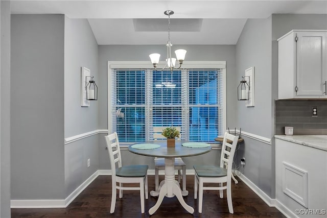 dining room with baseboards, dark wood-style floors, and a chandelier
