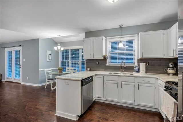 kitchen with a sink, gas stove, stainless steel dishwasher, a peninsula, and white cabinetry