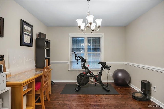 exercise area with a chandelier, wood finished floors, and baseboards