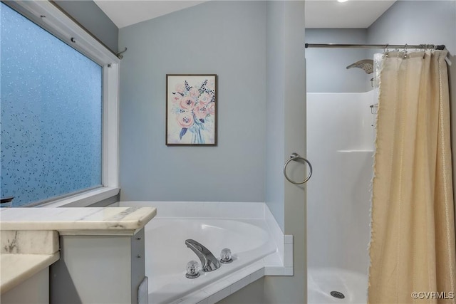 full bathroom with a stall shower and a garden tub