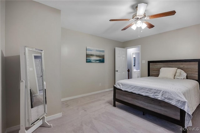 bedroom featuring light colored carpet, baseboards, and a ceiling fan