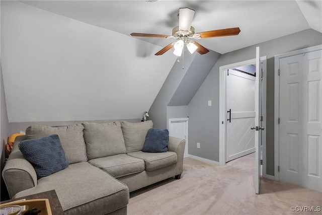 living room with vaulted ceiling, a ceiling fan, light carpet, and baseboards