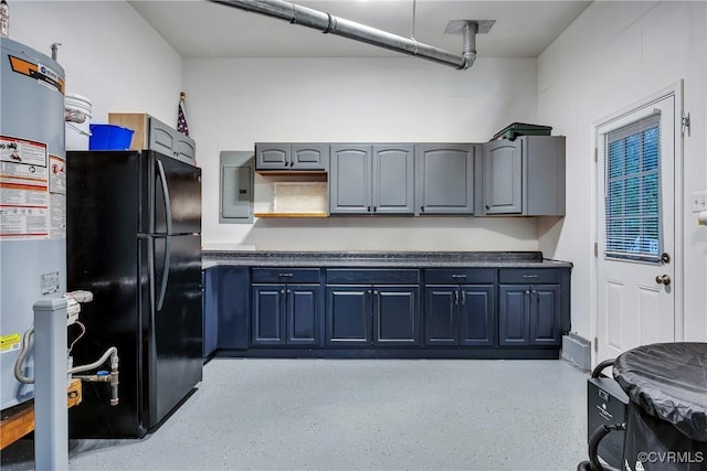 kitchen featuring freestanding refrigerator, electric panel, dark countertops, dark speckled floor, and gray cabinetry