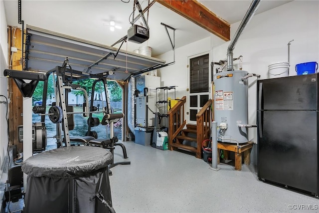 garage featuring freestanding refrigerator, water heater, and a garage door opener