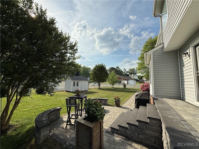 view of patio featuring an outdoor structure and a shed