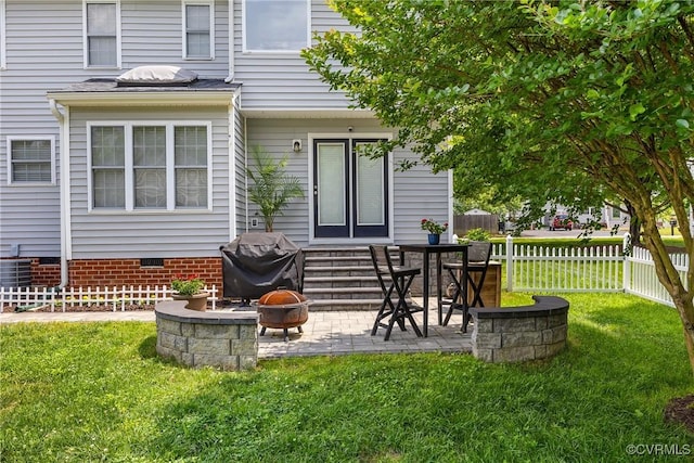 rear view of property with a patio, crawl space, and an outdoor fire pit