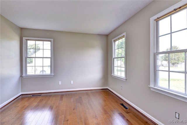 empty room featuring wood-type flooring and baseboards