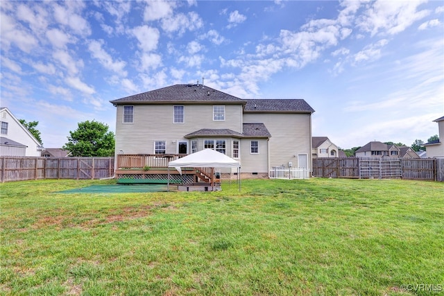rear view of property featuring a wooden deck and crawl space