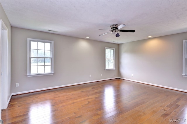 unfurnished room with ceiling fan, baseboards, wood finished floors, and recessed lighting