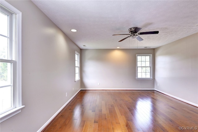 unfurnished room featuring hardwood / wood-style flooring, baseboards, ceiling fan, a textured ceiling, and recessed lighting