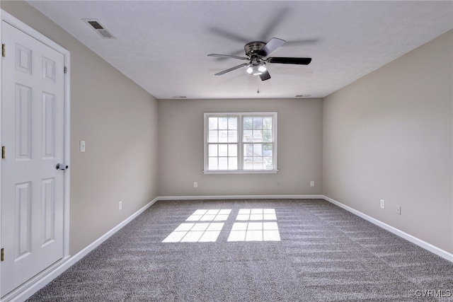 spare room with a ceiling fan, carpet, and baseboards