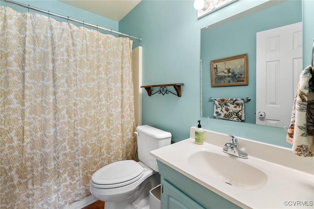 full bathroom with toilet and vanity