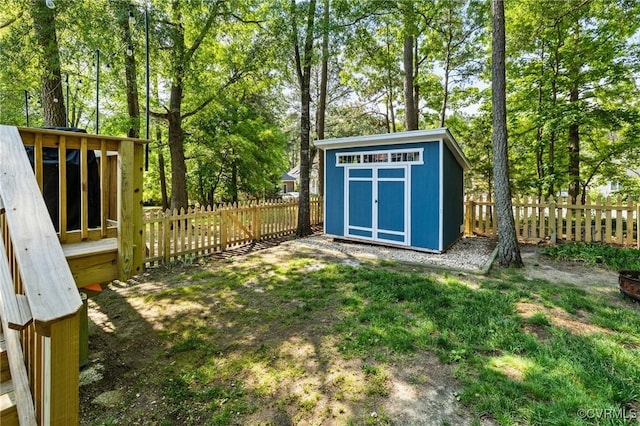 view of shed featuring a fenced backyard and view of scattered trees