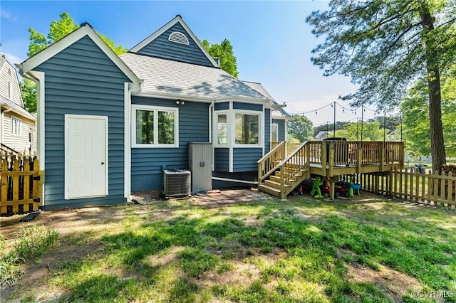 back of house featuring a deck, central AC unit, a shingled roof, and stairway