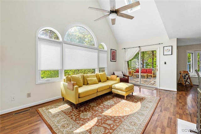 living room with high vaulted ceiling, ceiling fan, wood finished floors, and baseboards