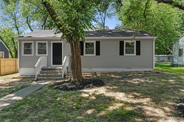 view of front facade with crawl space and a shingled roof