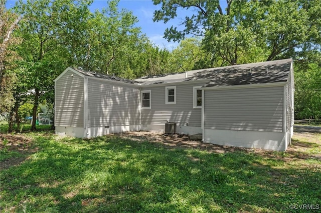 back of house featuring a lawn, crawl space, and central AC