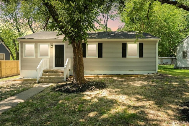 view of front of house with fence and crawl space
