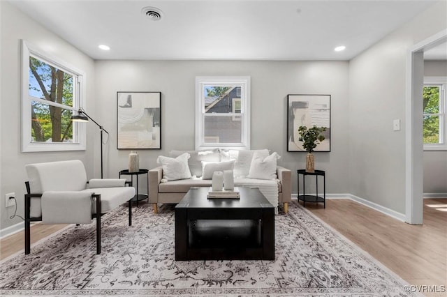 living room featuring wood finished floors, baseboards, and recessed lighting