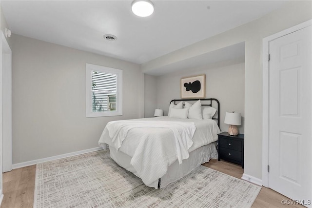 bedroom with baseboards and light wood-style flooring