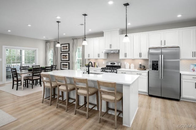 9 Abercrombie Dr, Chesterfield, VA 23838 - kitchen featuring stainless steel appliances, under cabinet range hood, light wood-type flooring, decorative backsplash, and recessed lighting