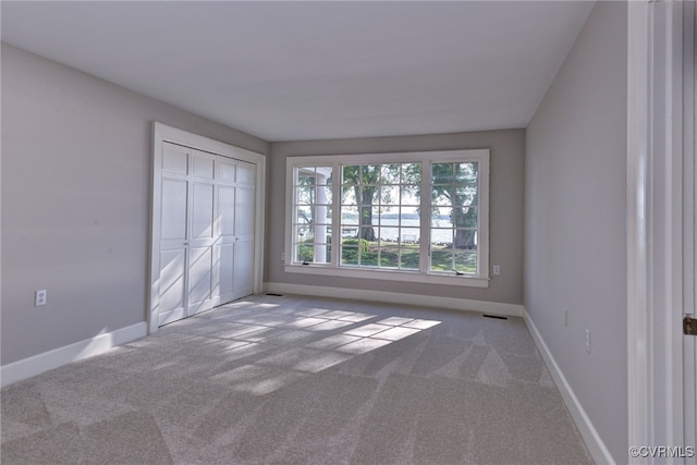 6454 Carmines Island Ln, Gloucester, VA 23072 - unfurnished bedroom with carpet, baseboards, and a closet