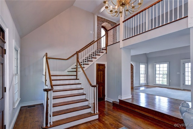 6454 Carmines Island Ln, Gloucester, VA 23072 - entrance foyer with high vaulted ceiling, wood finished floors, a chandelier, stairs, and baseboards