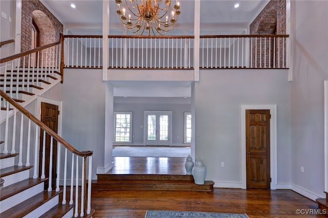 6454 Carmines Island Ln, Gloucester, VA 23072 - stairway with wood finished floors, a high ceiling, a chandelier, baseboards, and recessed lighting