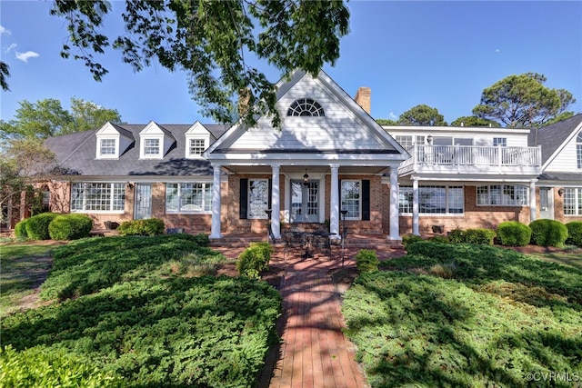 6454 Carmines Island Ln, Gloucester, VA 23072 - view of front of home featuring brick siding, a chimney, and covered porch