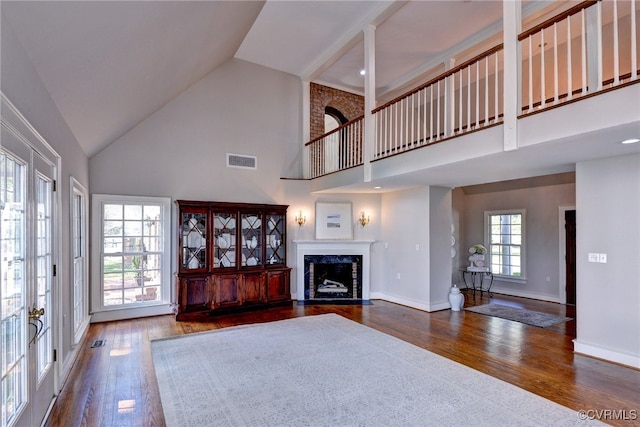 6454 Carmines Island Ln, Gloucester, VA 23072 - living room with high vaulted ceiling, hardwood / wood-style flooring, a premium fireplace, and baseboards