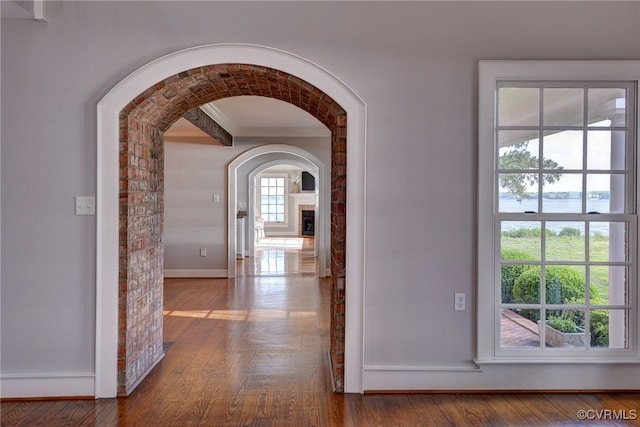 6454 Carmines Island Ln, Gloucester, VA 23072 - hallway featuring wood finished floors, baseboards, and arched walkways