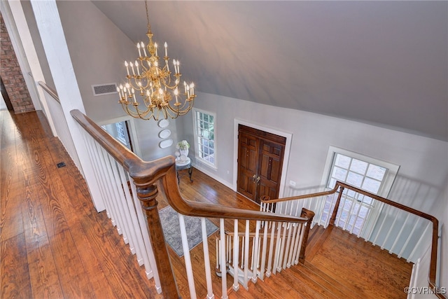 6454 Carmines Island Ln, Gloucester, VA 23072 - stairs with lofted ceiling, hardwood / wood-style flooring, and a chandelier