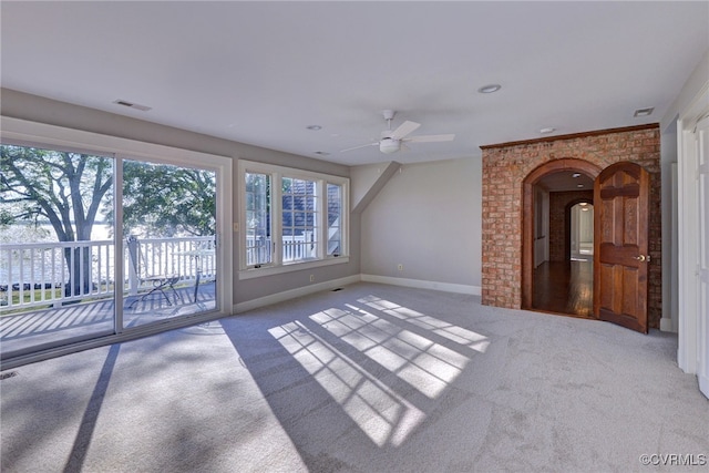 6454 Carmines Island Ln, Gloucester, VA 23072 - unfurnished living room with carpet flooring, a ceiling fan, baseboards, and arched walkways