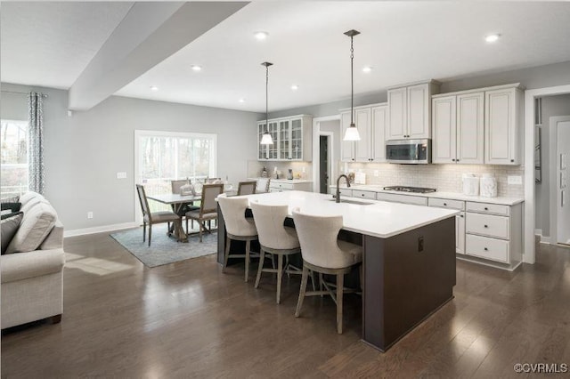 11 Abercrombie Dr, Chesterfield, VA 23838 - kitchen featuring stainless steel microwave, a sink, gas stovetop, baseboards, and dark wood-style floors