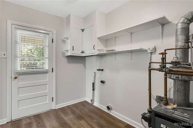 washroom featuring cabinet space, dark wood-style flooring, baseboards, hookup for an electric dryer, and hookup for a washing machine