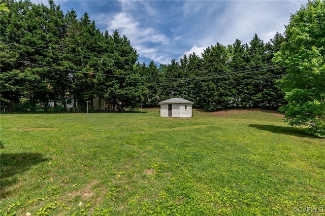 view of green lawn with a storage unit and an outdoor structure
