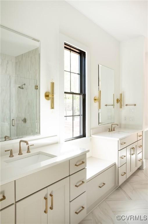 bathroom with a stall shower, plenty of natural light, and vanity