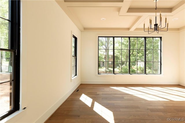 unfurnished room featuring a chandelier, baseboards, wood finished floors, and coffered ceiling