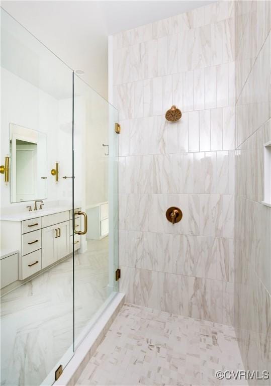 bathroom featuring a shower stall and vanity