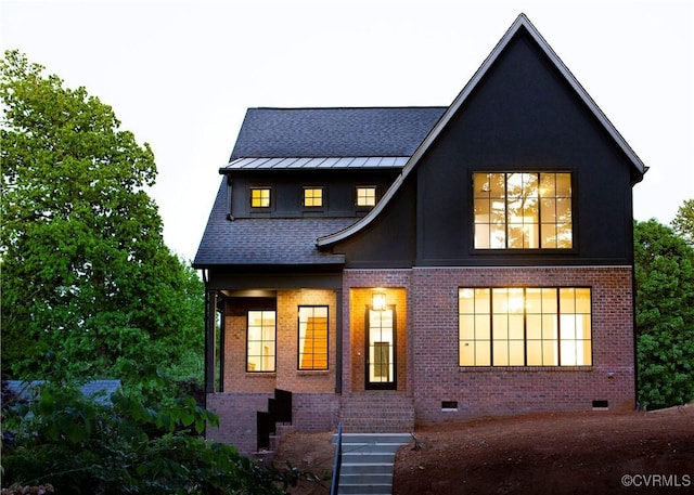 back of property with stairway, brick siding, crawl space, a shingled roof, and a standing seam roof