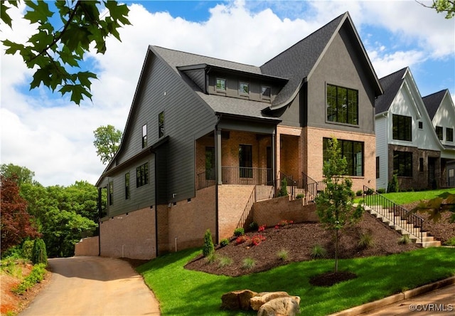 2005 Southcliff Rd, Richmond, VA 23225 - view of front of home with stairway, covered porch, brick siding, and a front lawn