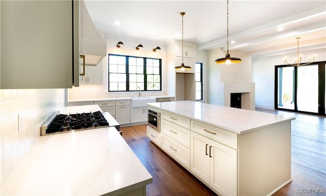 2005 Southcliff Rd, Richmond, VA 23225 - kitchen featuring a sink, stainless steel gas cooktop, decorative backsplash, light countertops, and dark wood-style floors